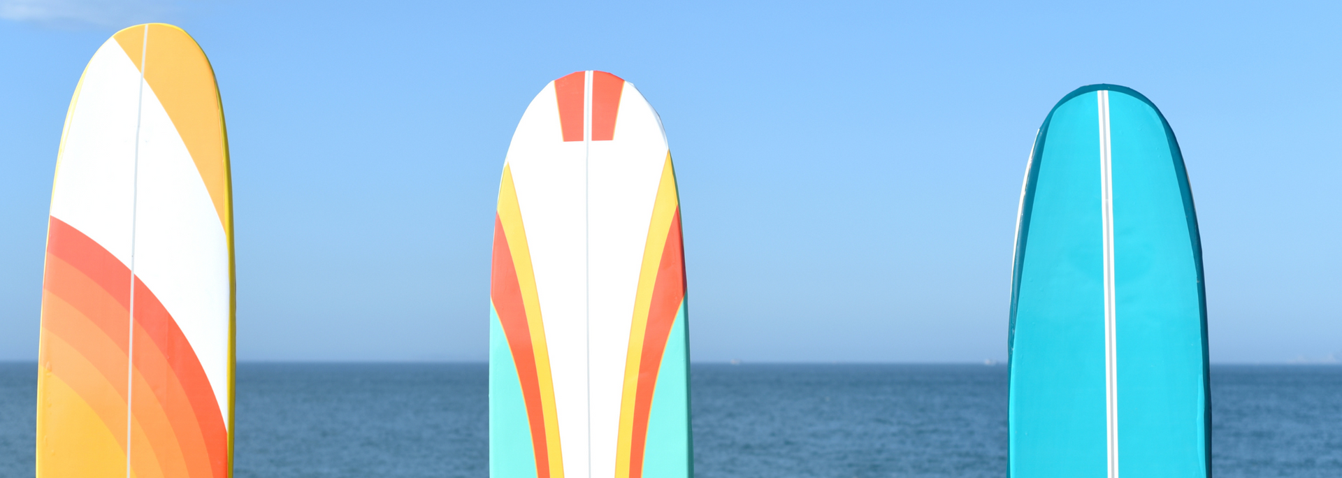 Picture of several surfboards in a line. Picture of several surfboards in a line.