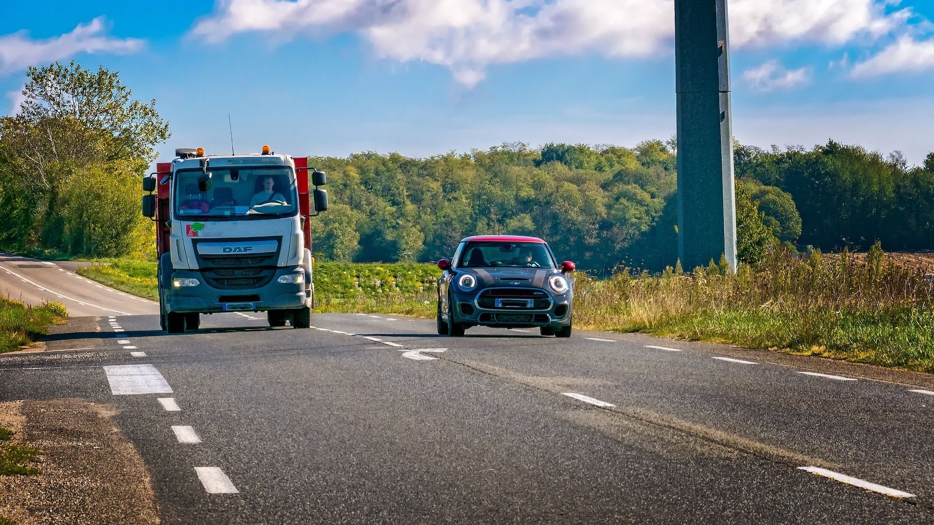 Picture of a car overtaking a truck
