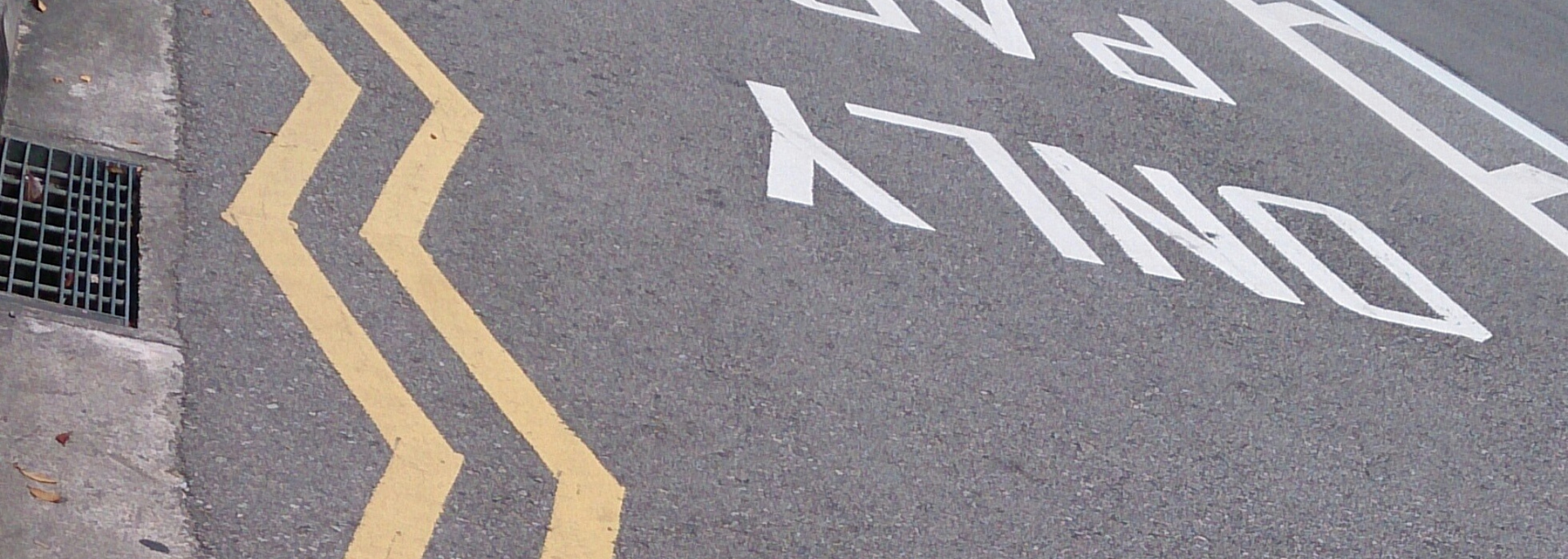 Picture of yellow zig-zags on road.
