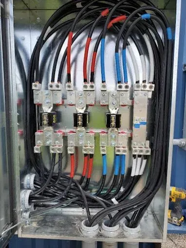 A bunch of wires are connected to a metal box.