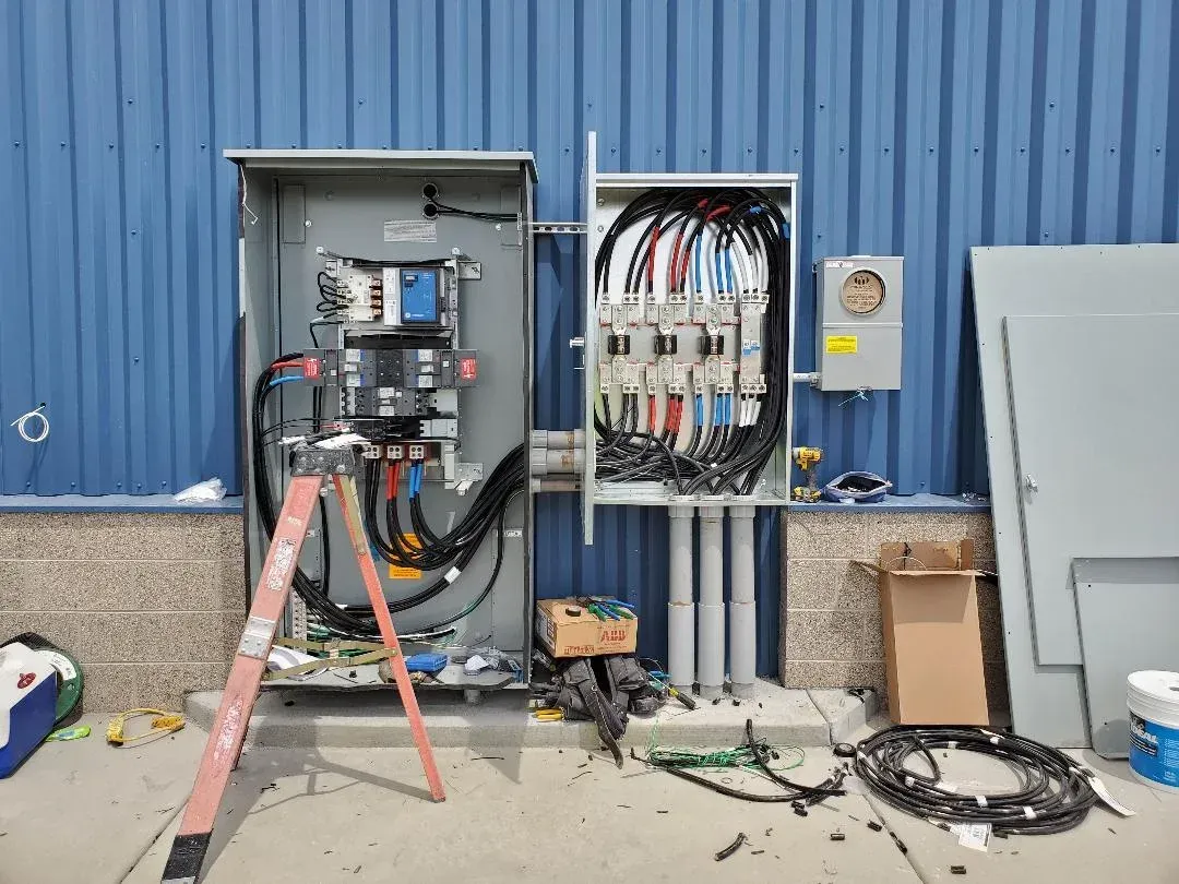 A ladder is sitting next to a large electrical box.
