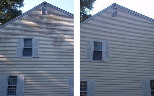 A side-by-side comparison of a house exterior showing before and after cleaning of dirty, stained vinyl siding.