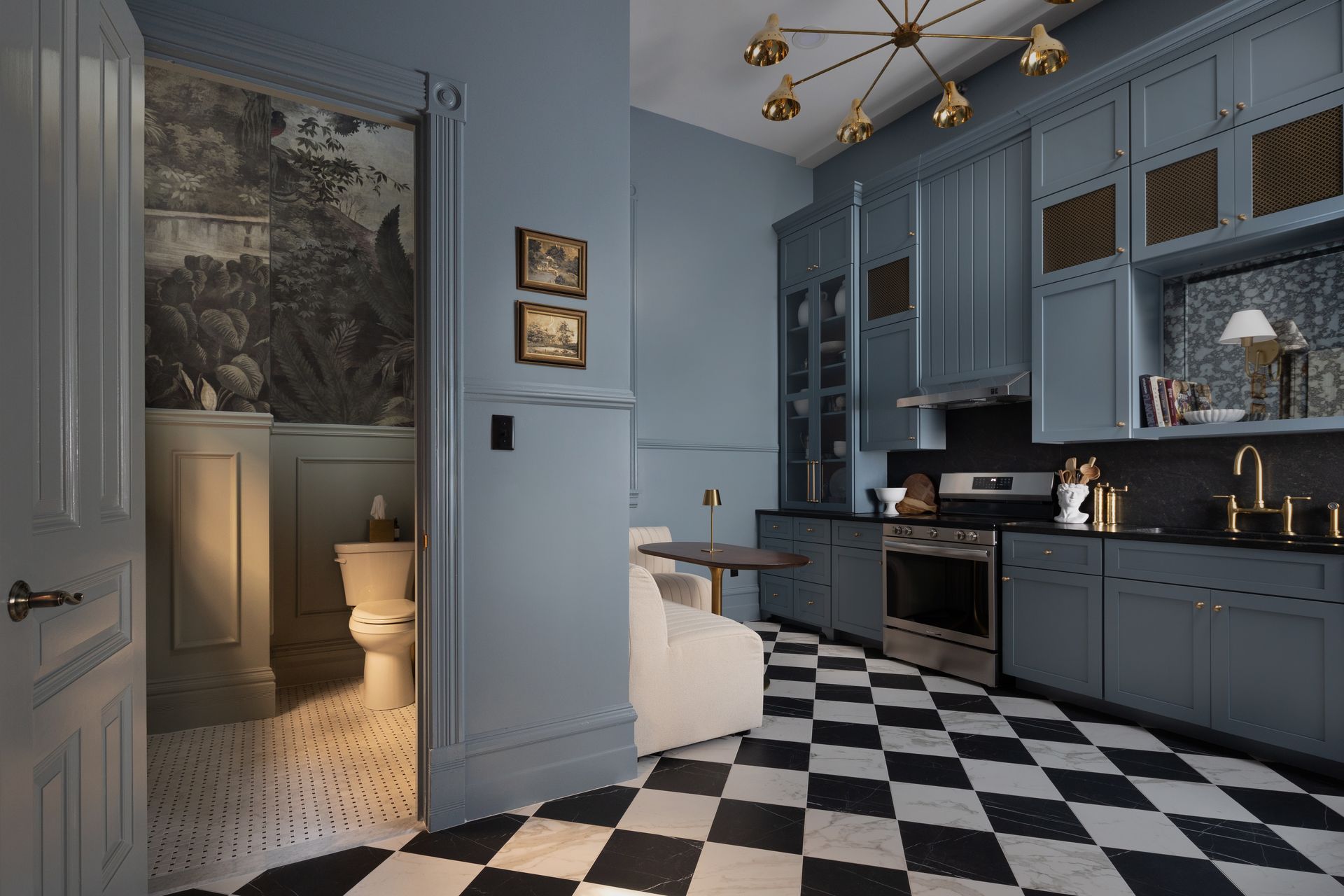 A kitchen with blue cabinets and a checkered floor