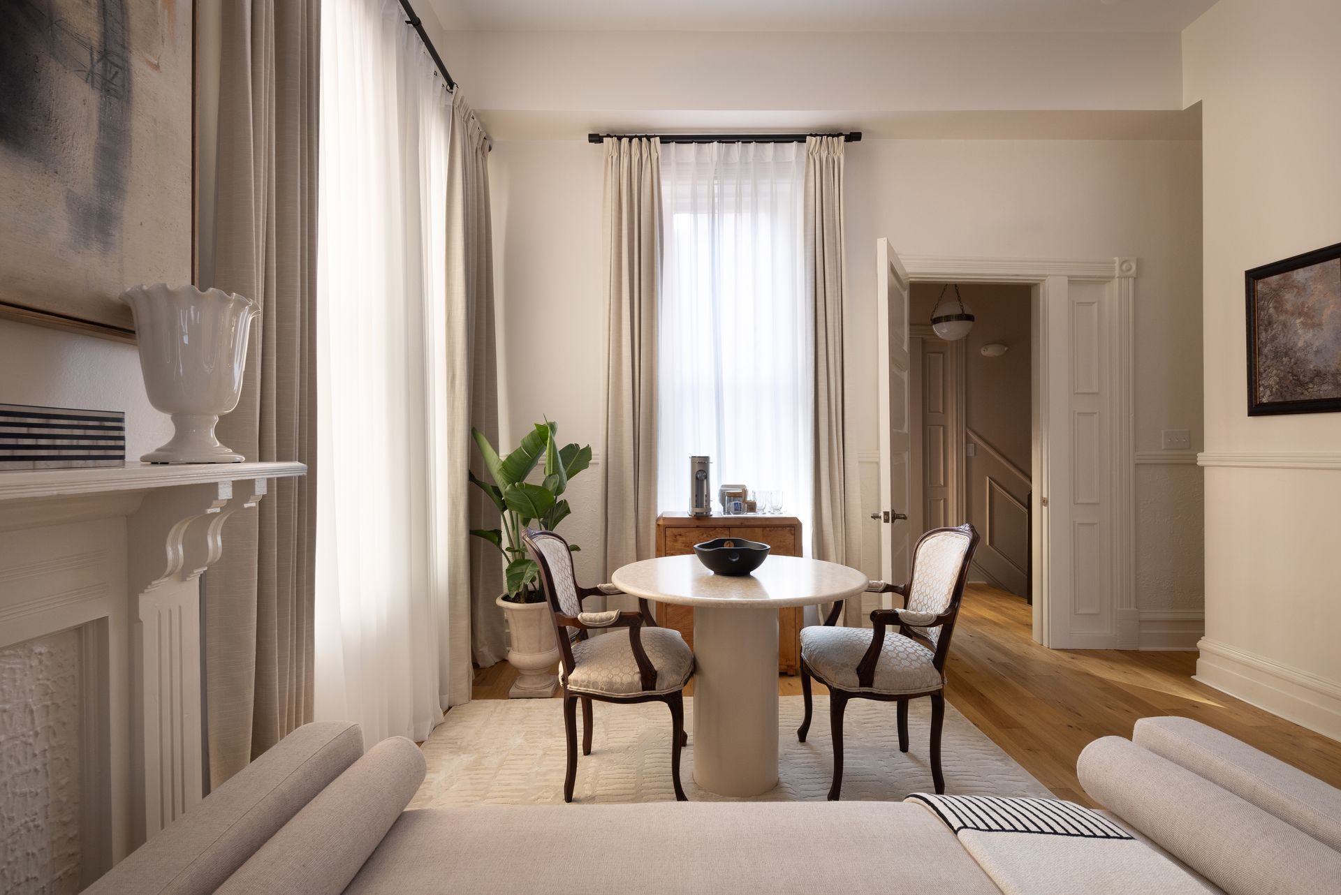 A living room with a table and chairs and a fireplace.