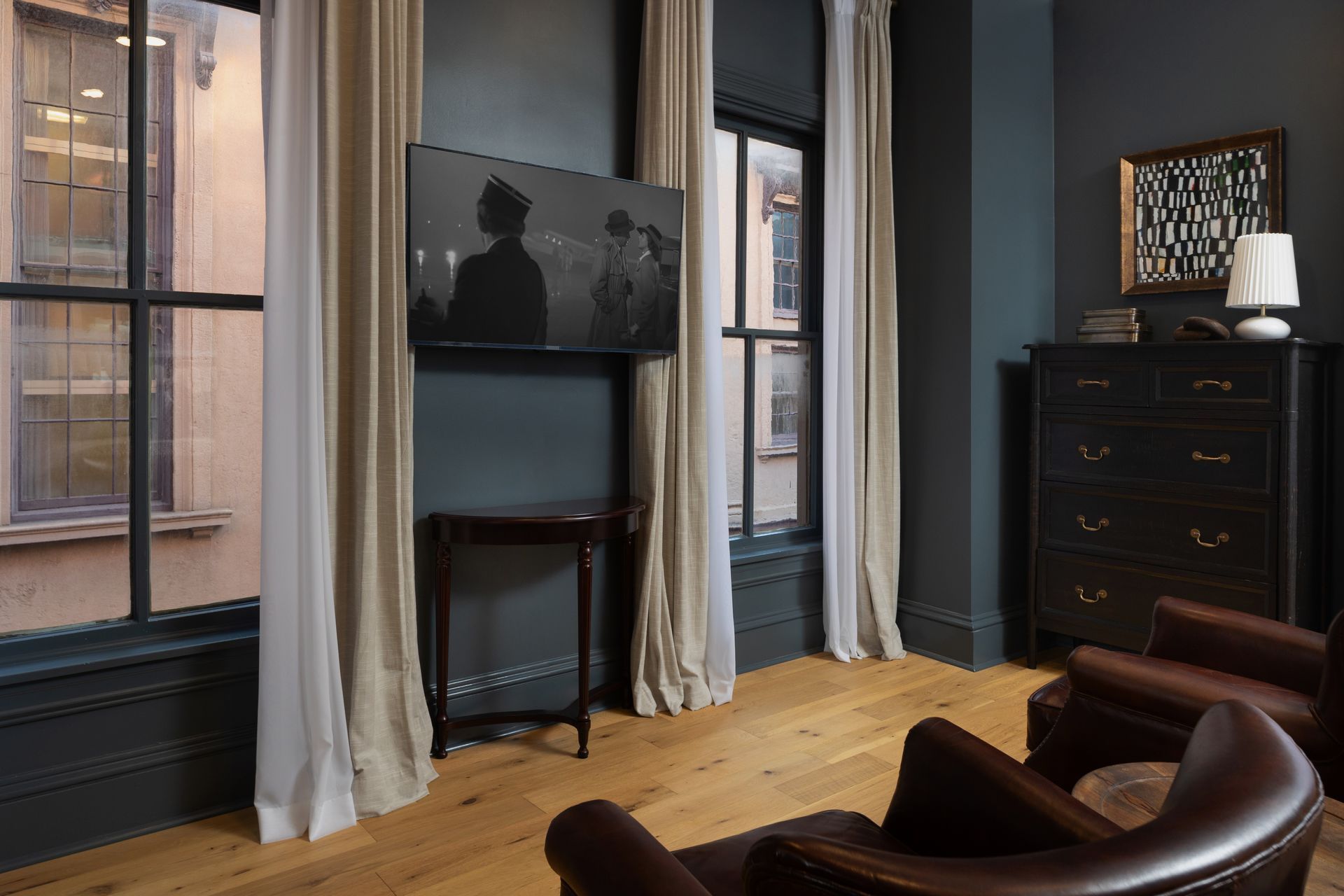 A living room with two chairs and a flat screen tv