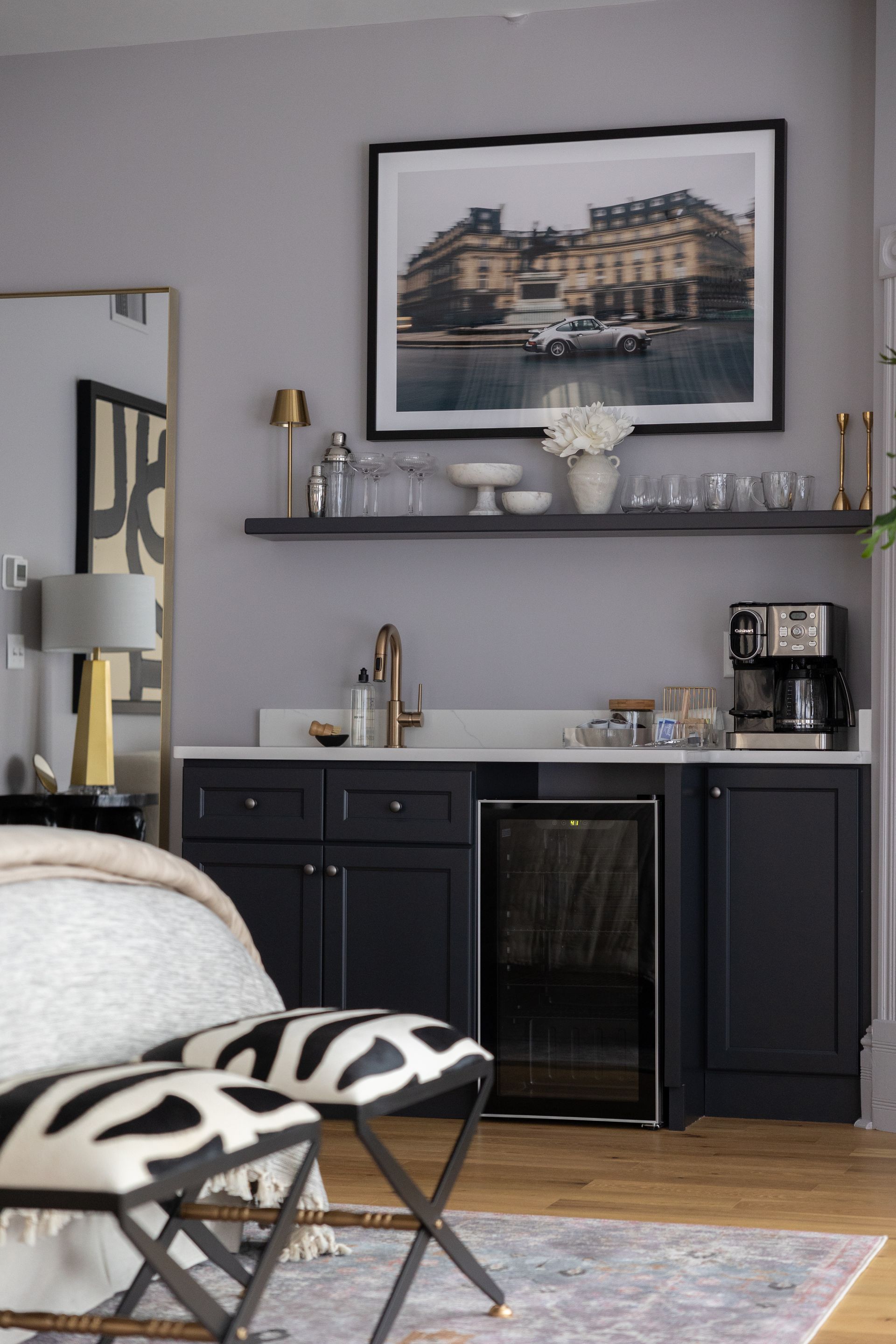 There is a picture on the wall above the counter in the room.