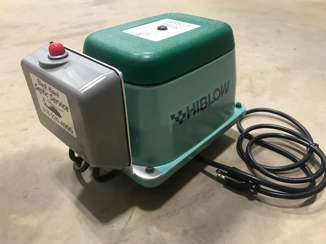 Green and gray HiBlow air pump with power cord and control box.