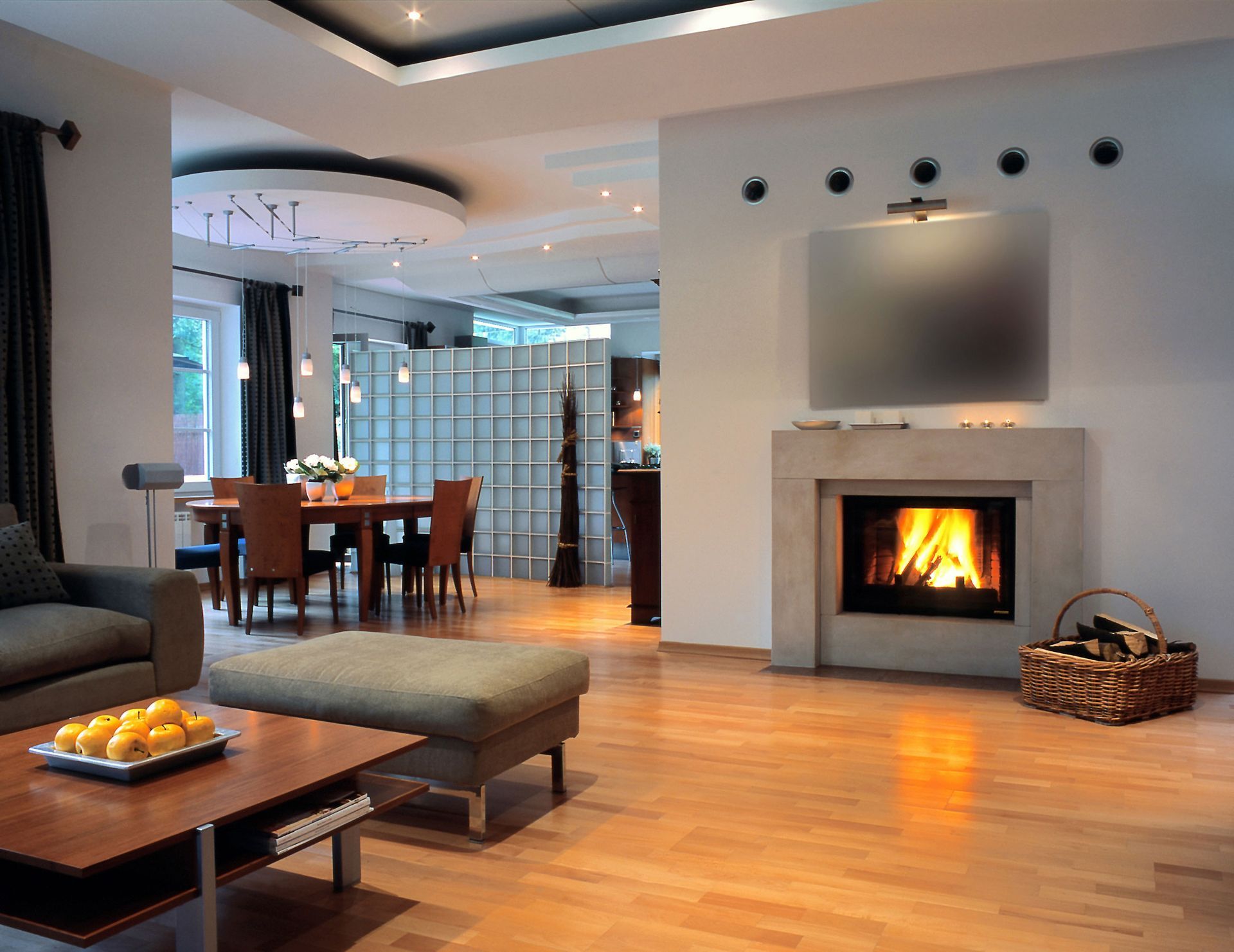 A living room with a fireplace and dining table