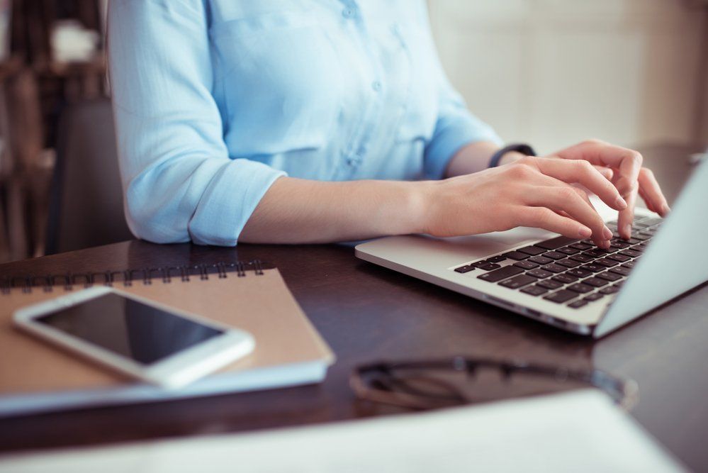 event manager working on her laptop