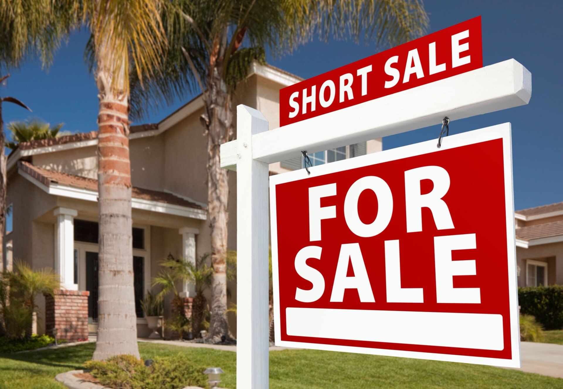 A house with a for sale sign in front of it, representing the topic of short sale law.