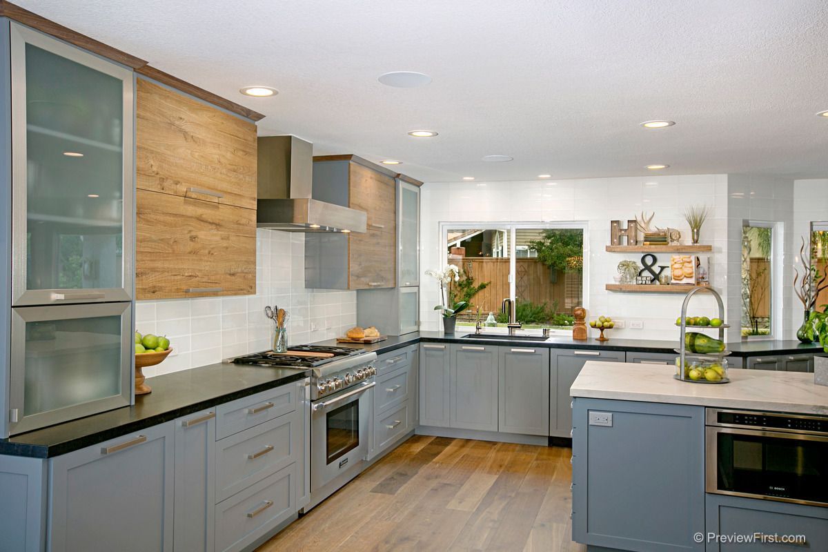 A large kitchen with a large island in the middle of it.