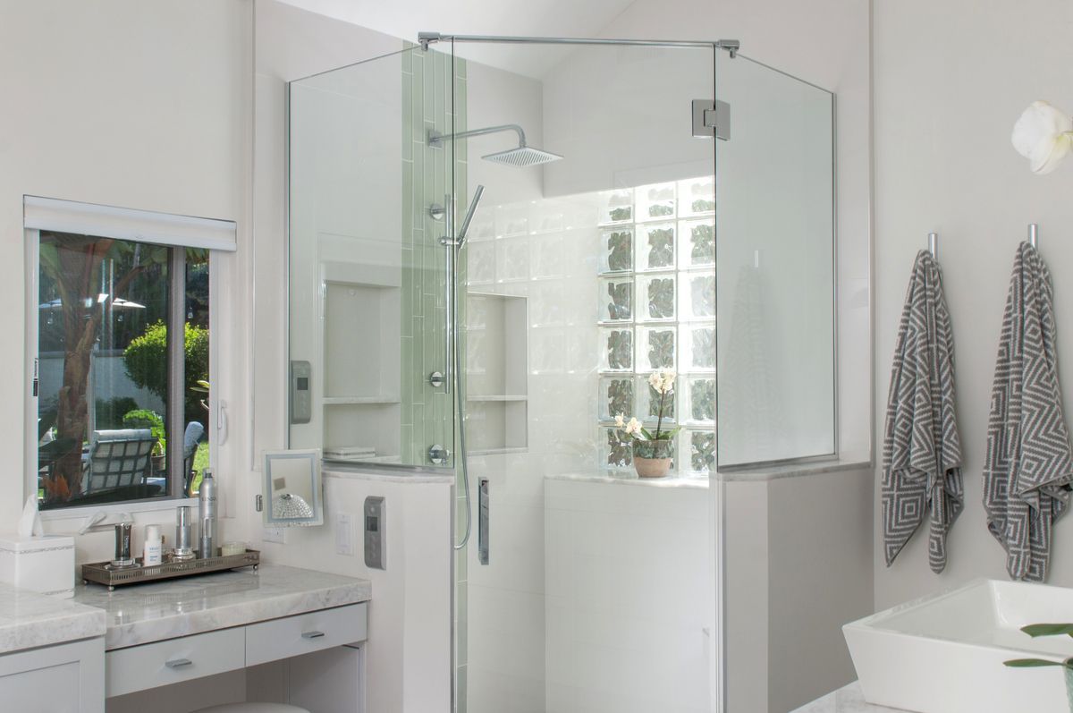 A bathroom with a walk in shower and a bathtub.