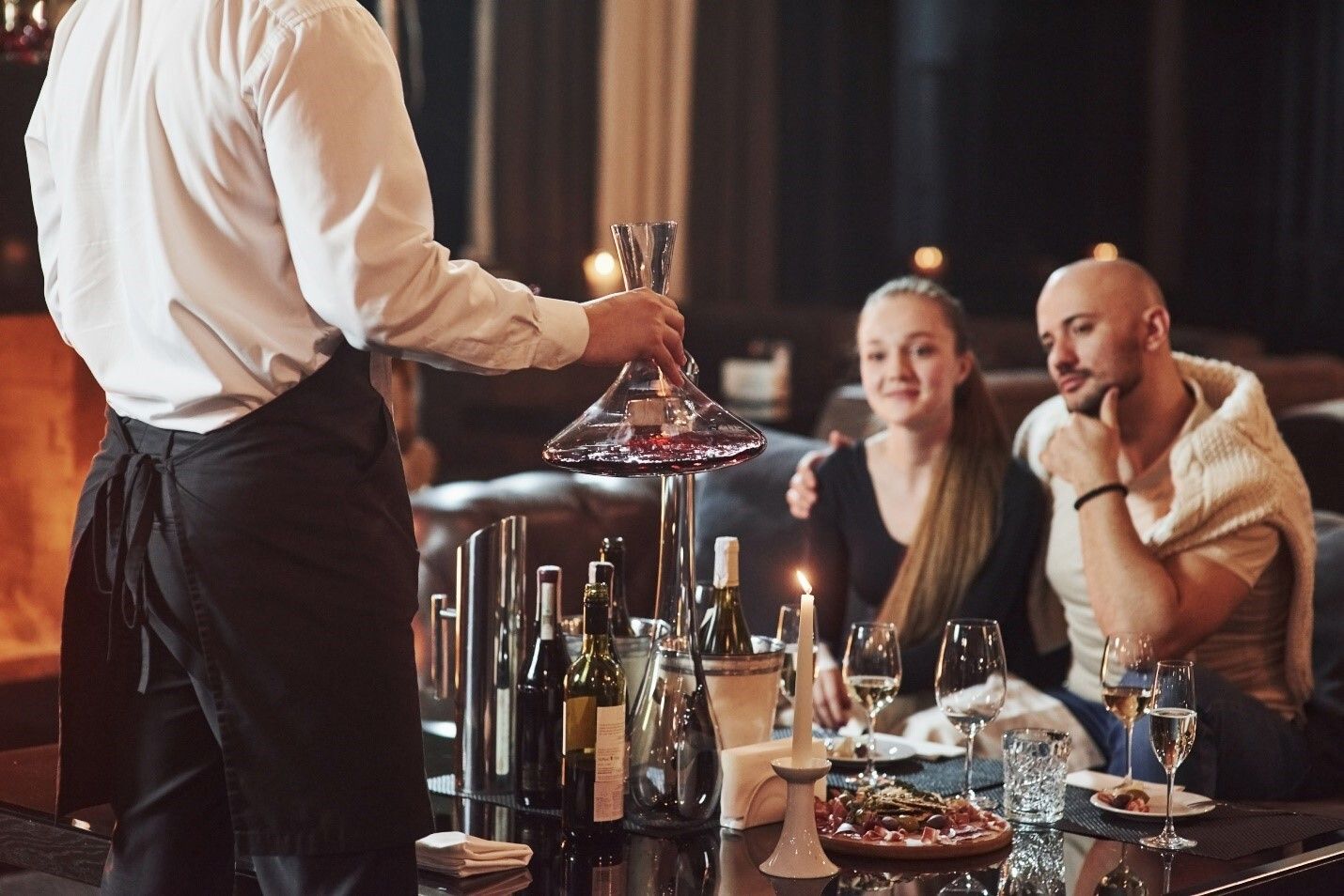 Couple With Wine Bottle Waiter