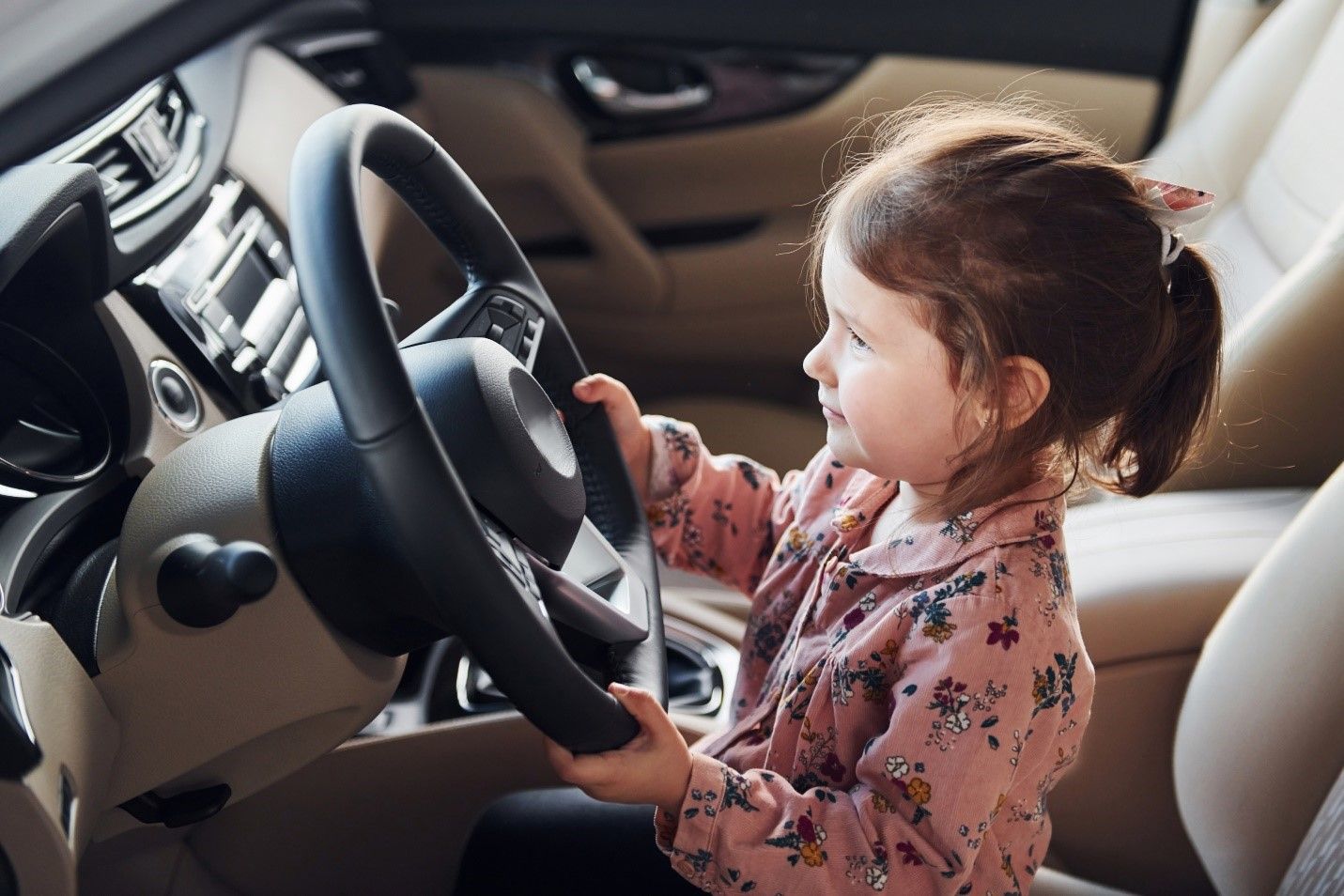 A Child Holding the Steering Wheel