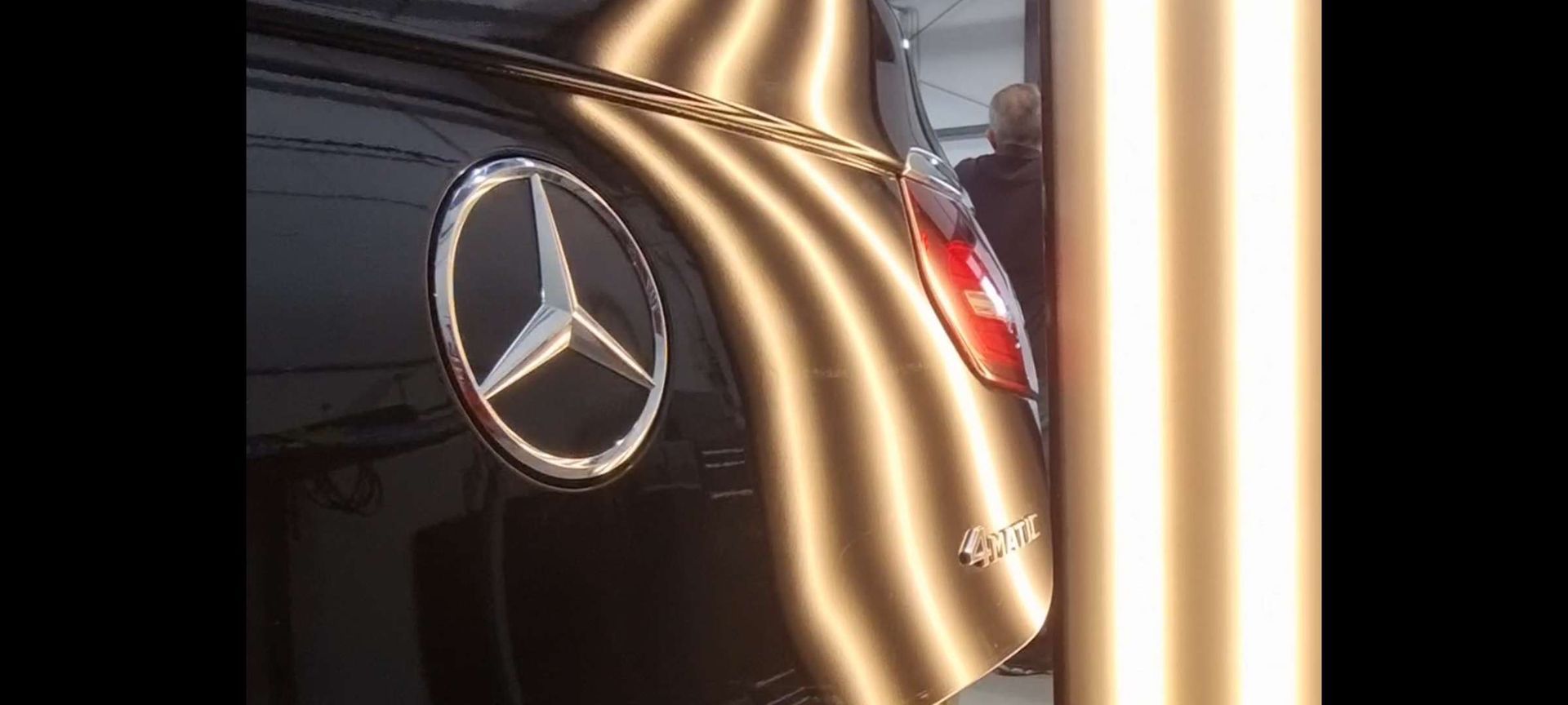 a black mercedes with dents removed