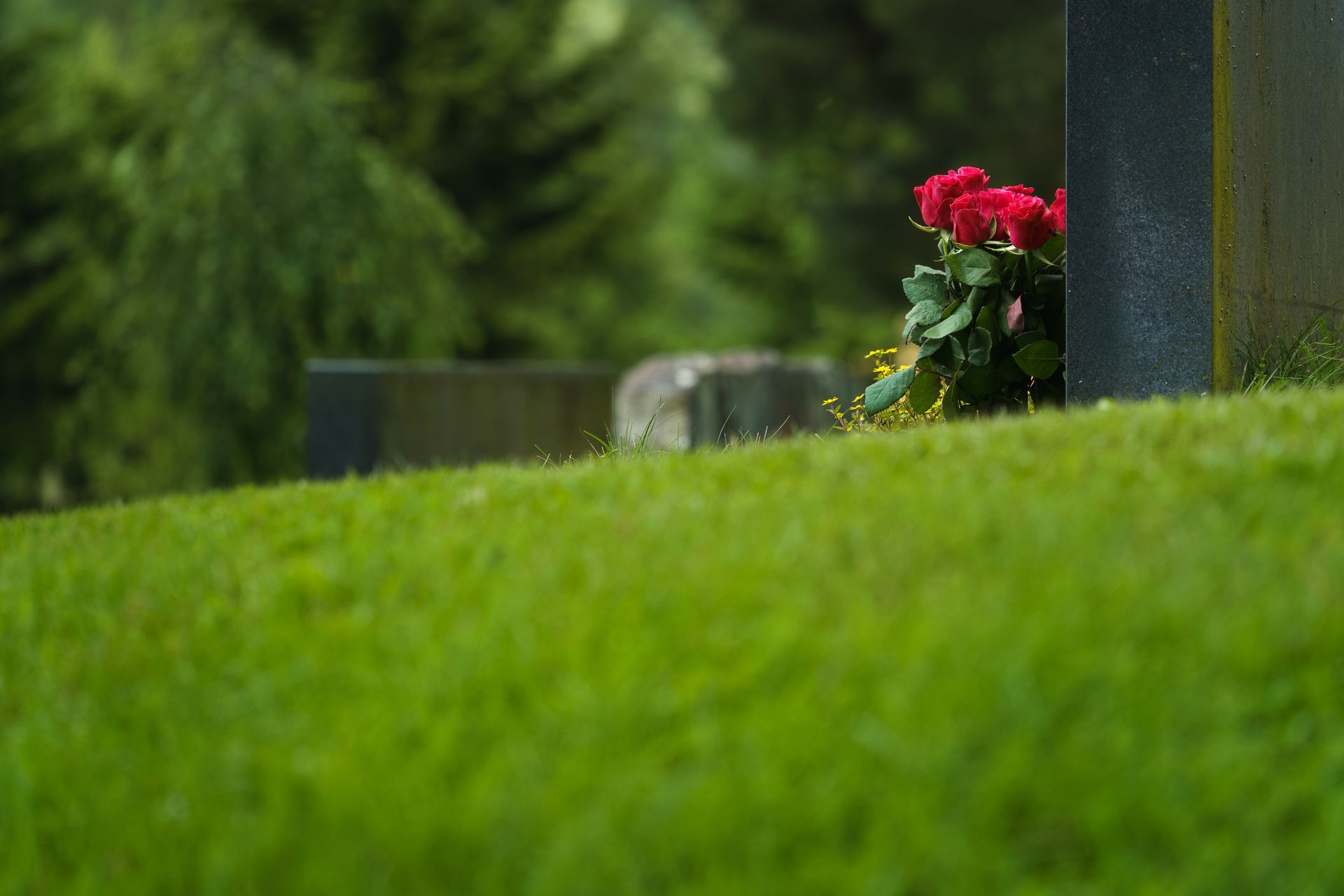 a blue coffin with flowers on it is sitting on a table .