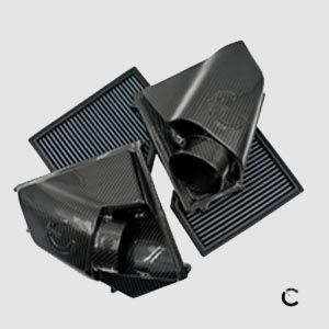 A group of air filters are stacked on top of each other on a white surface.