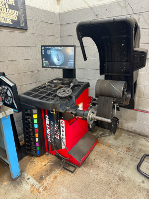 A hunter wheel balancer is sitting in a garage