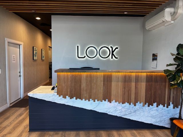 A reception area with a sign that says look