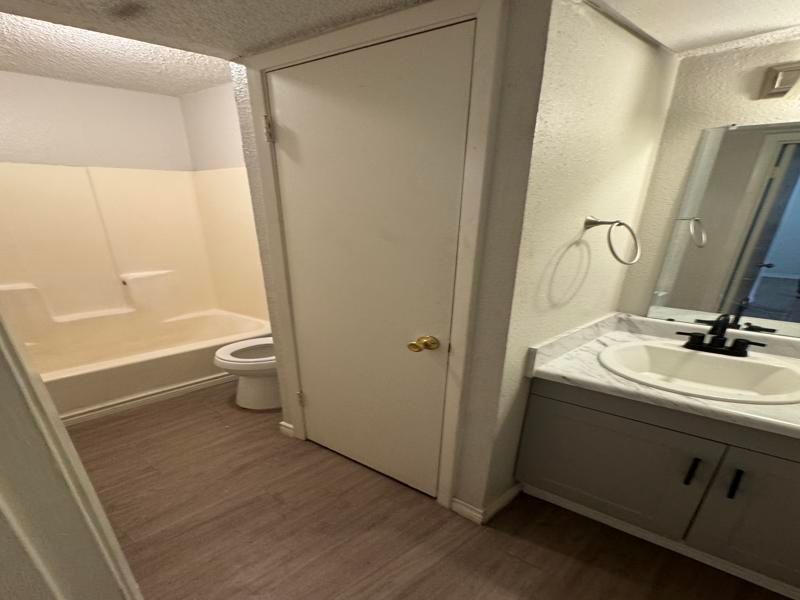A bathroom with a sink , toilet and bathtub