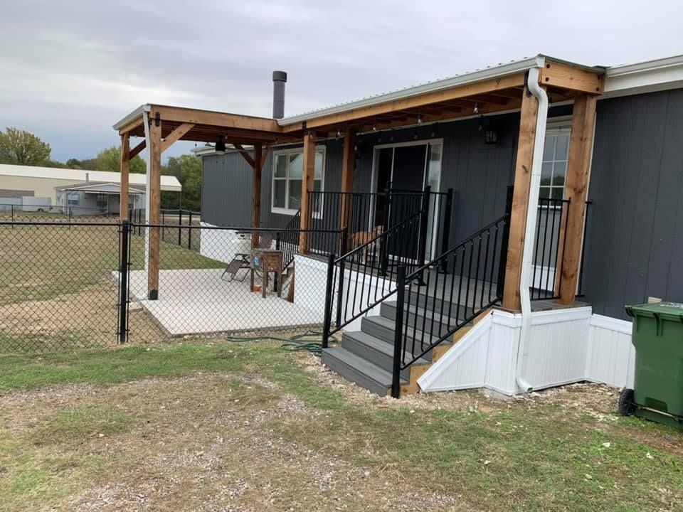 A mobile home with a porch and stairs.