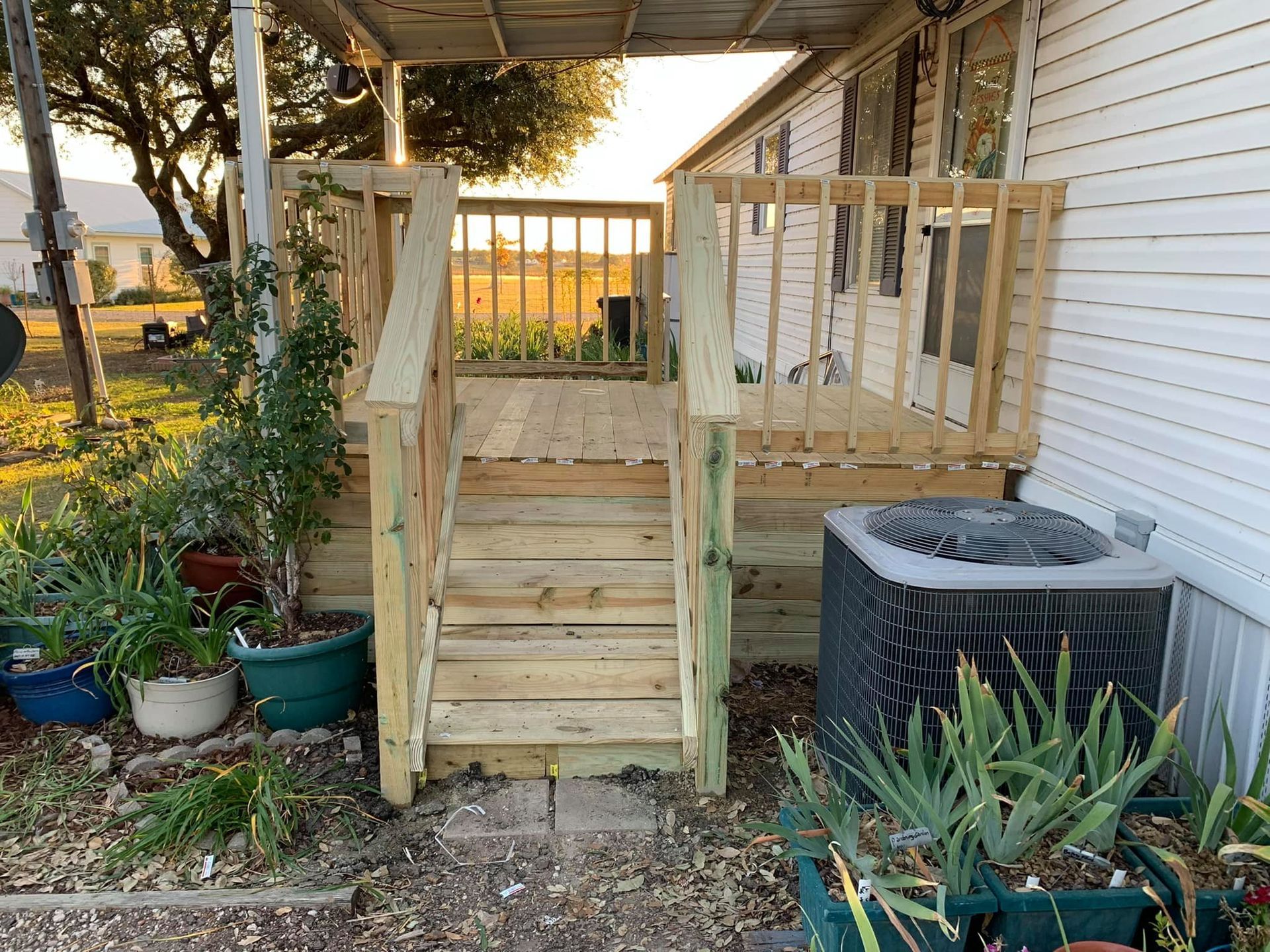 A mobile home with a wooden deck and stairs