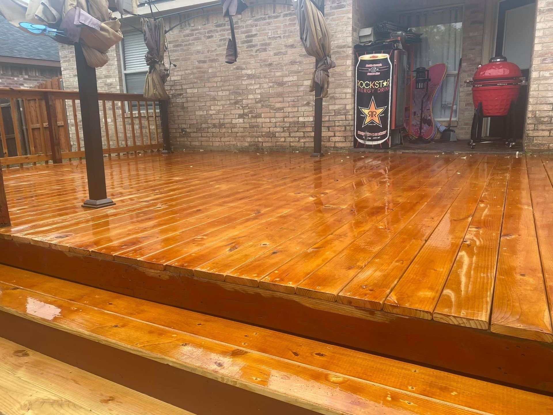A wooden deck is sitting in front of a brick building.