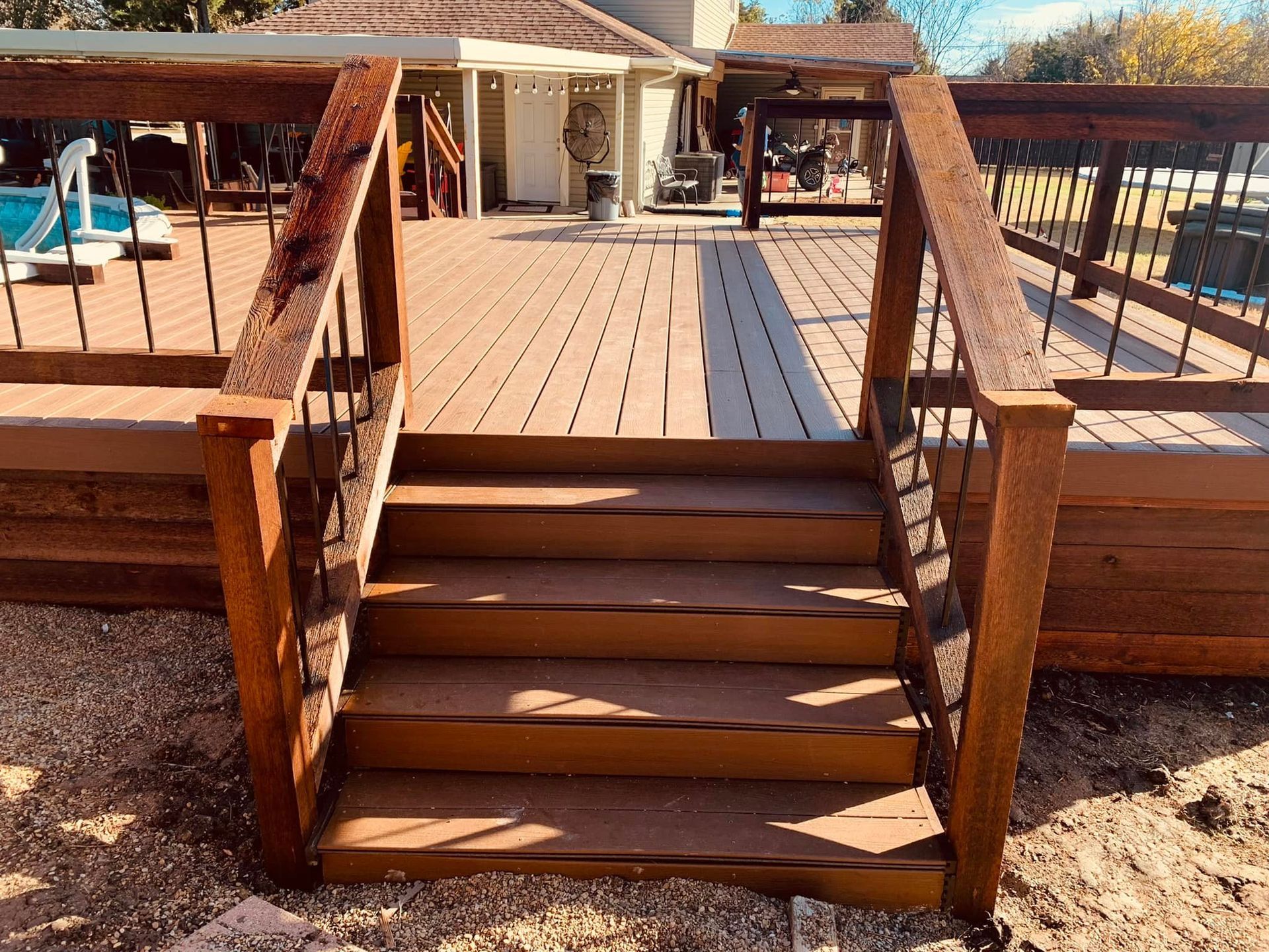 A wooden deck with stairs leading up to it.