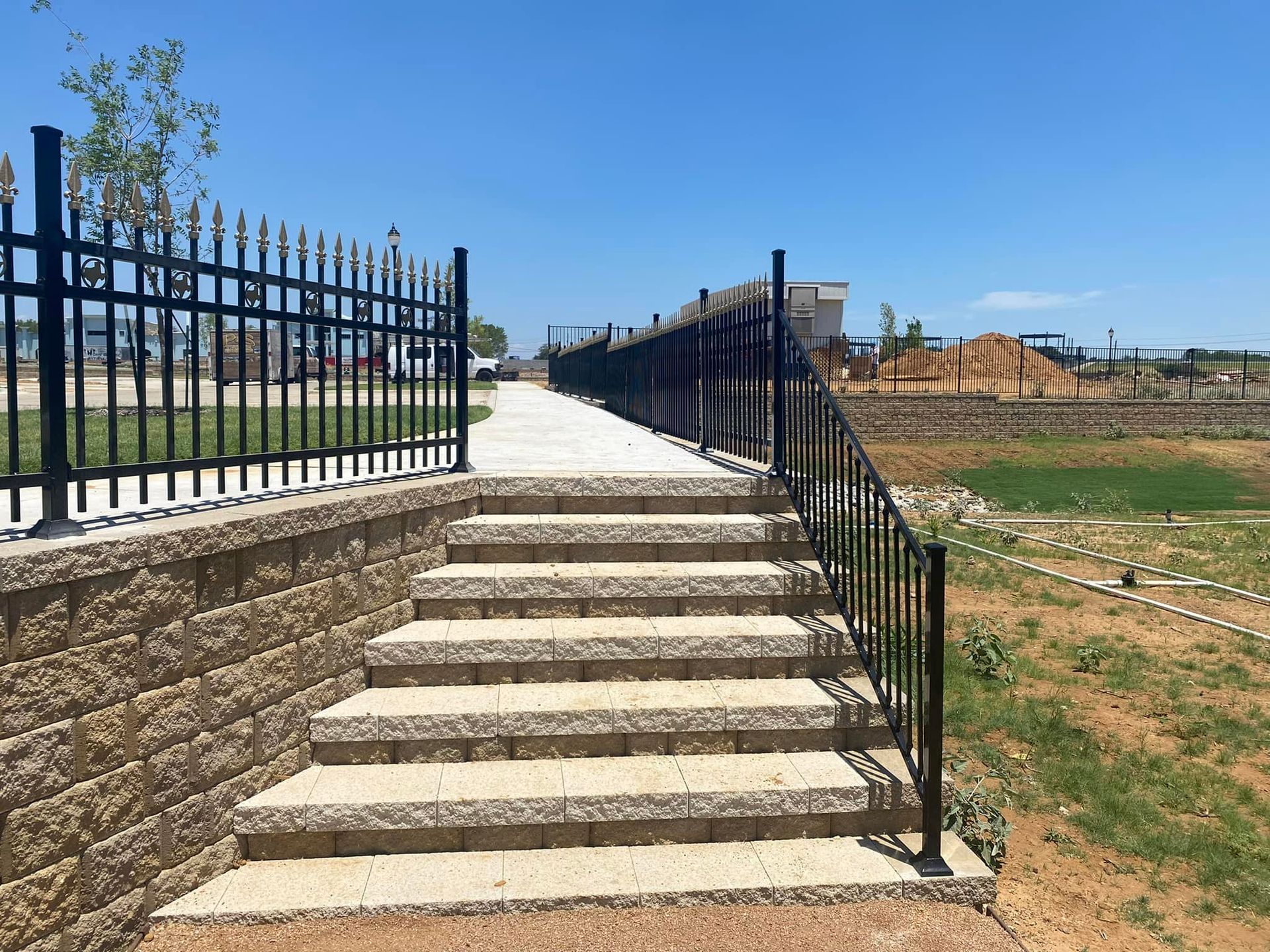 A set of stairs leading up to a fence in a park