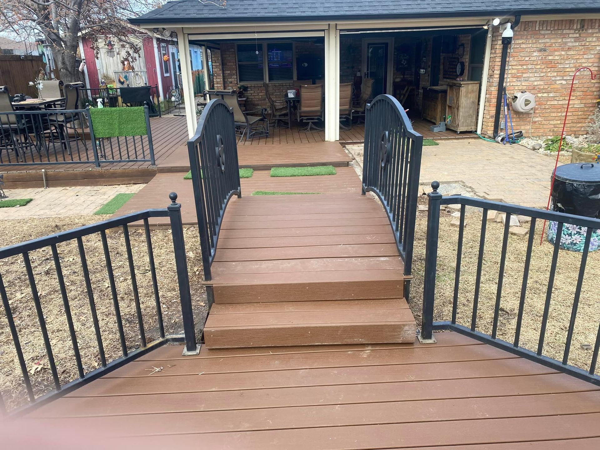 A wooden deck with stairs leading to a house