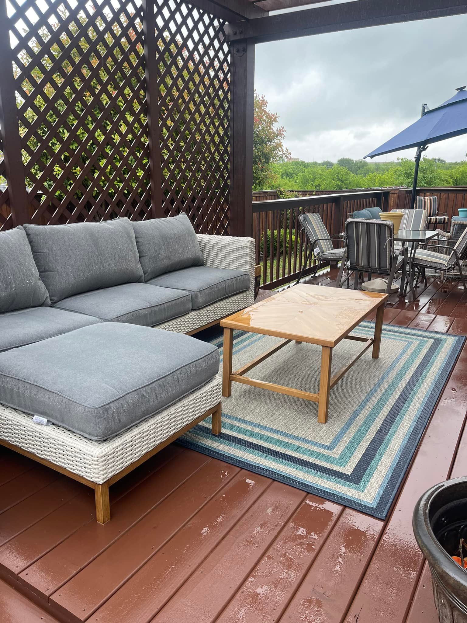 There is a couch and a coffee table on the deck.