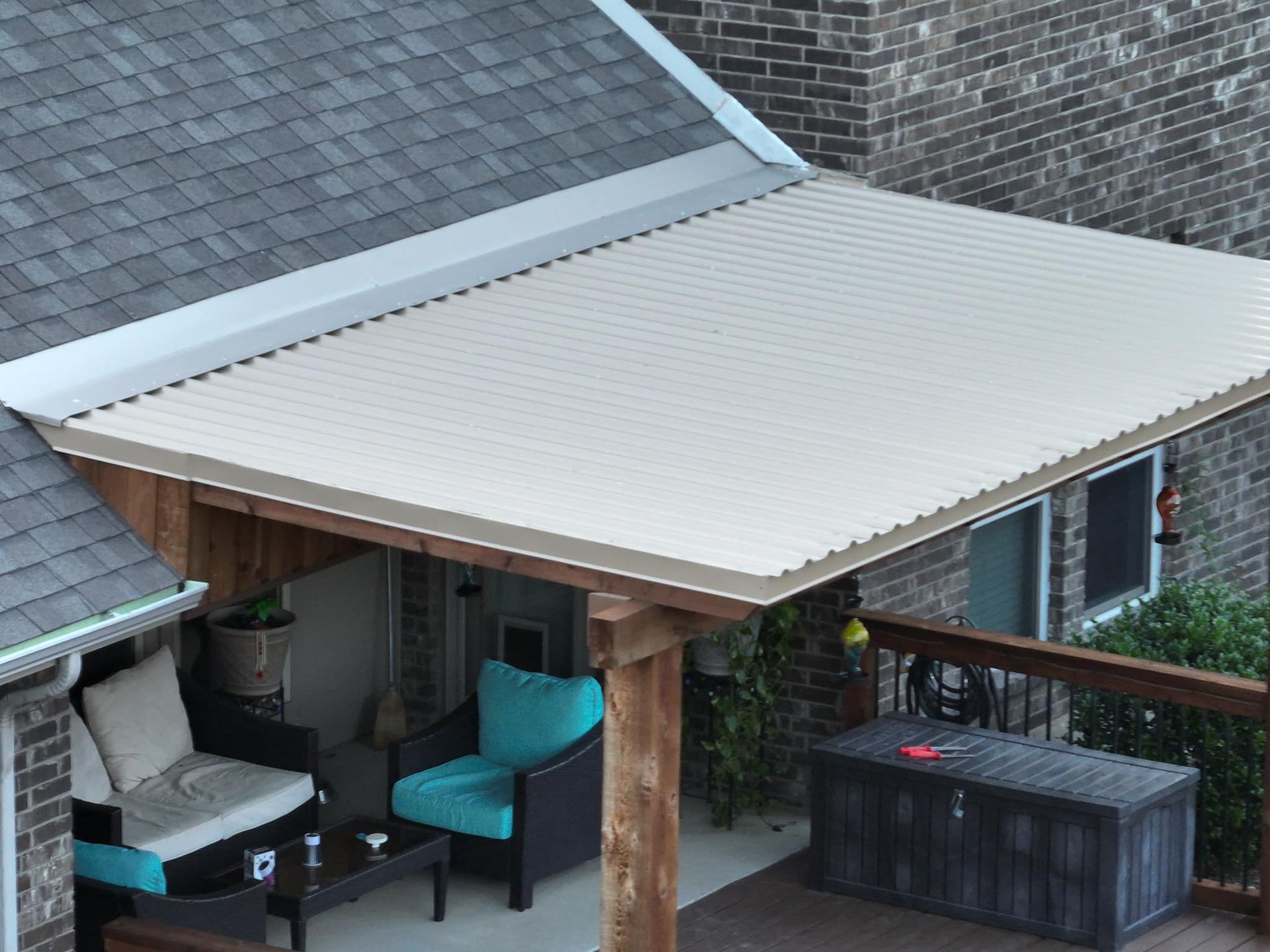 An aerial view of a patio with furniture and a roof
