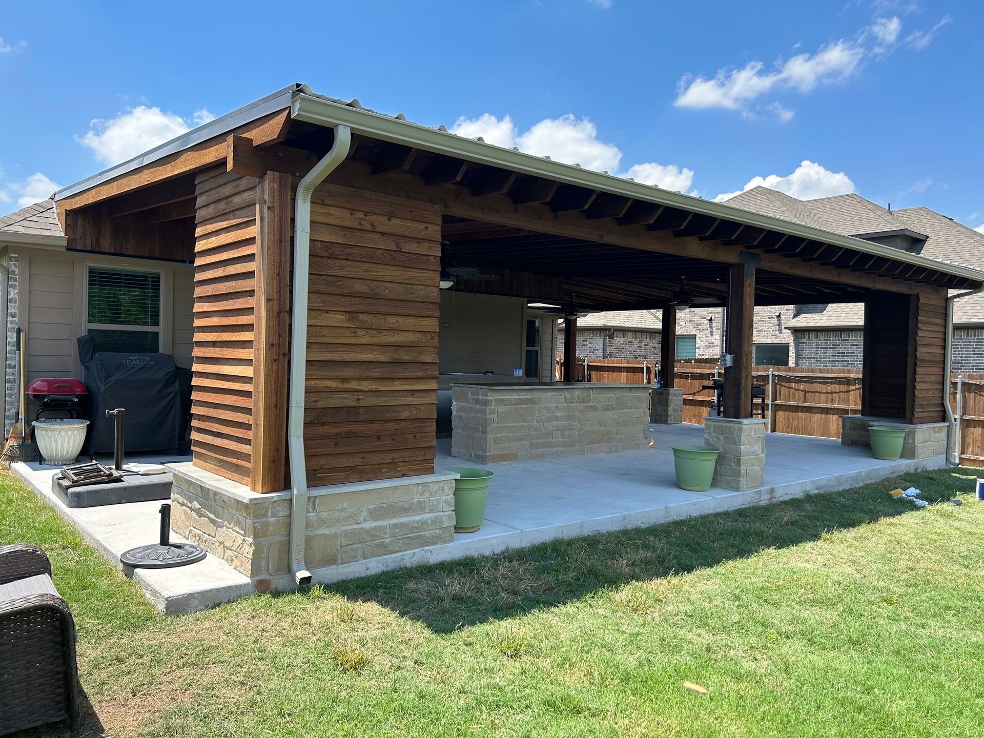 A house with a large covered patio area in the backyard.