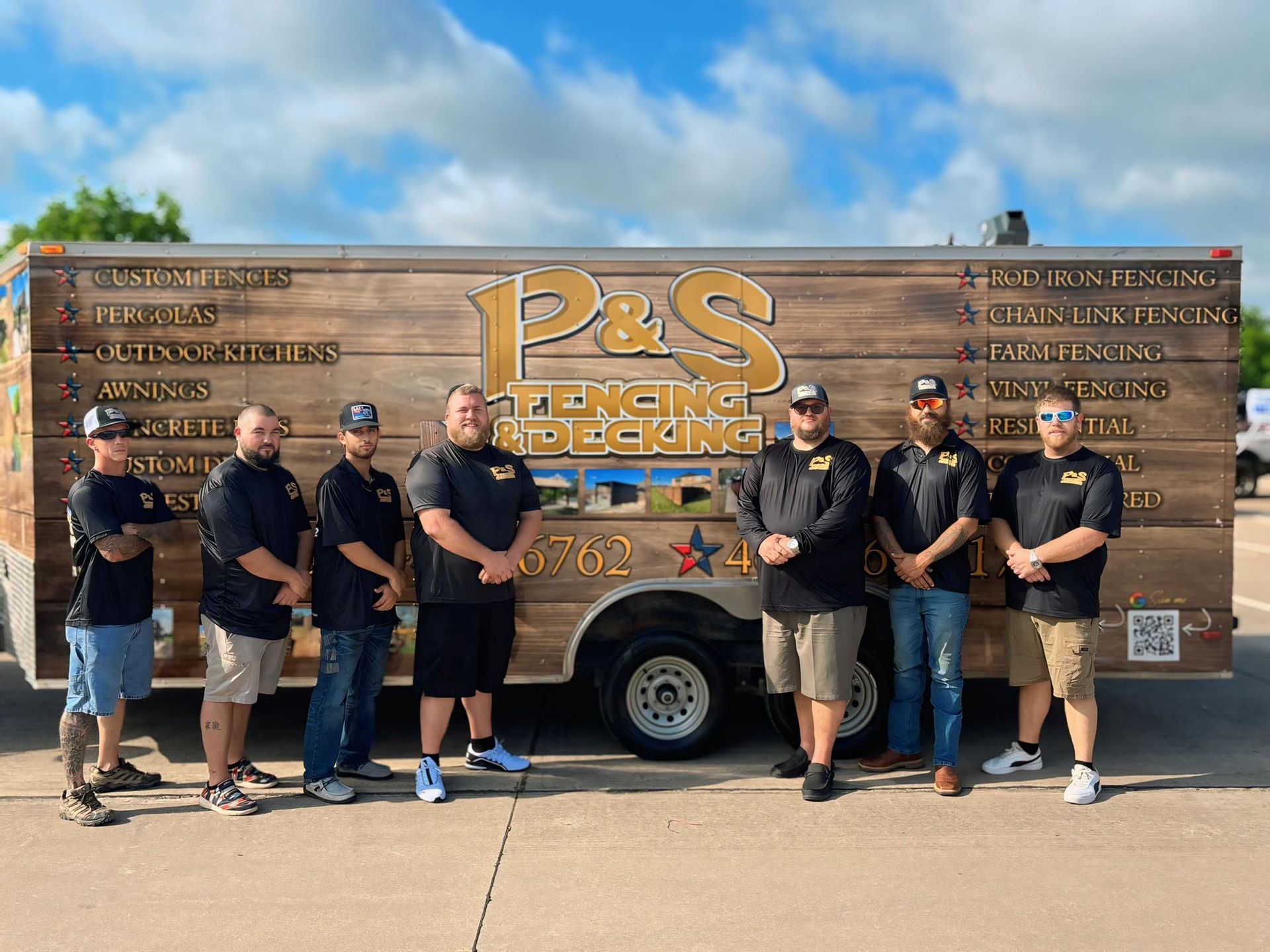 A group of men are posing for a picture in front of a p & s truck.
