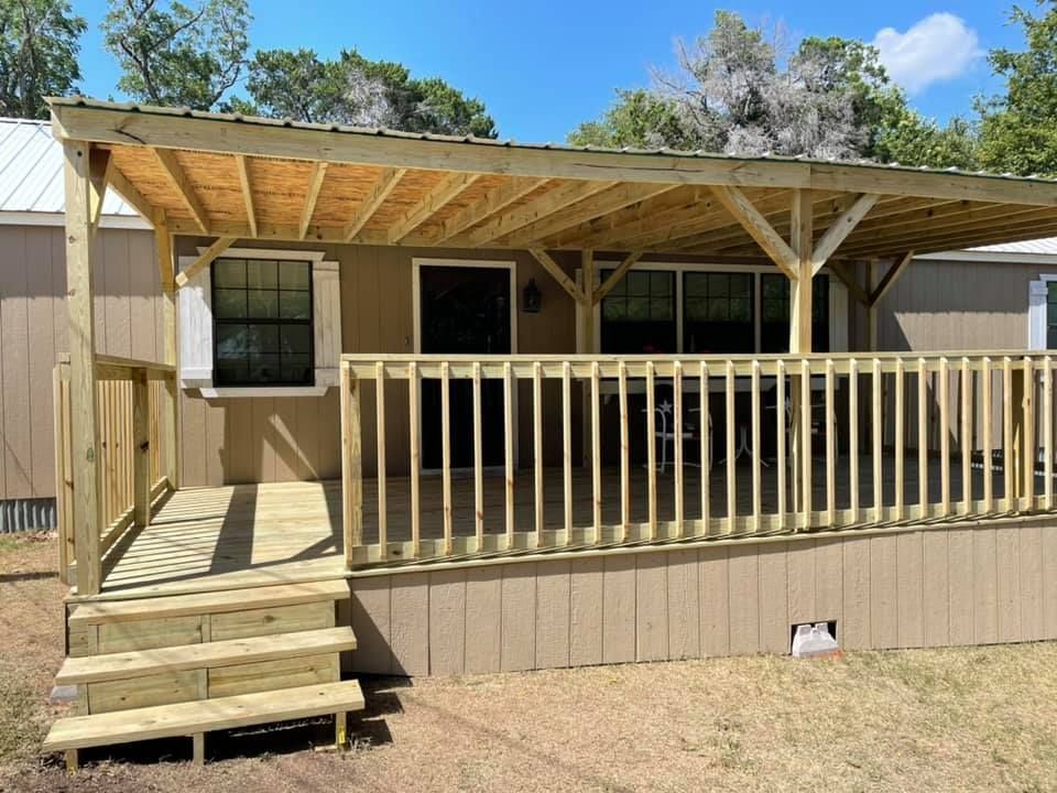 A mobile home with a wooden deck and stairs