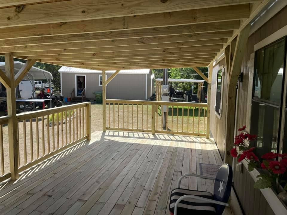 A wooden deck with chairs and flowers on it