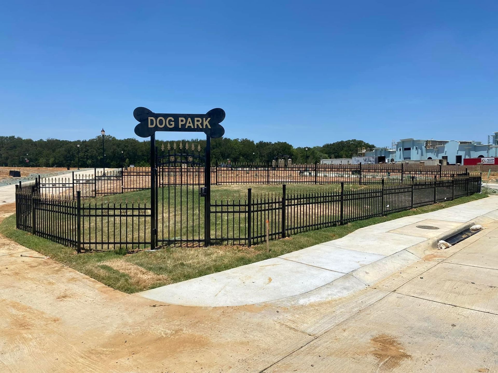 A dog park with a fence and a sign that says dog park.