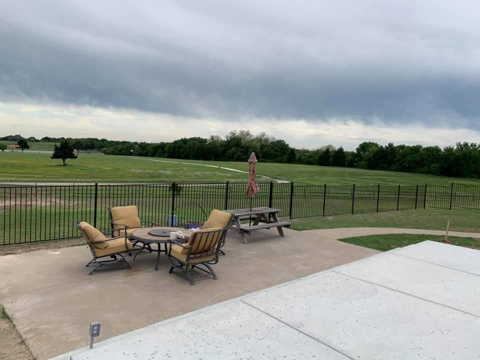A patio with a table and chairs and a picnic table.