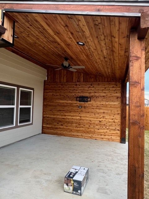 A patio with a wooden ceiling and a box on the ground