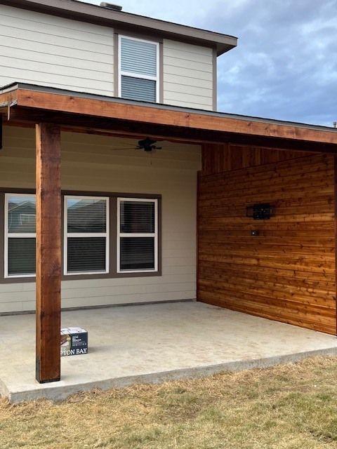 A house with a wooden covered patio in front of it