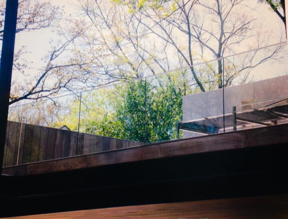 A bathroom with a walk in shower with a sliding glass door.
