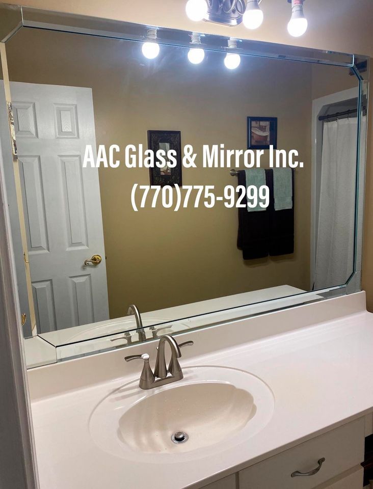 A bathroom with a walk in shower with a sliding glass door.