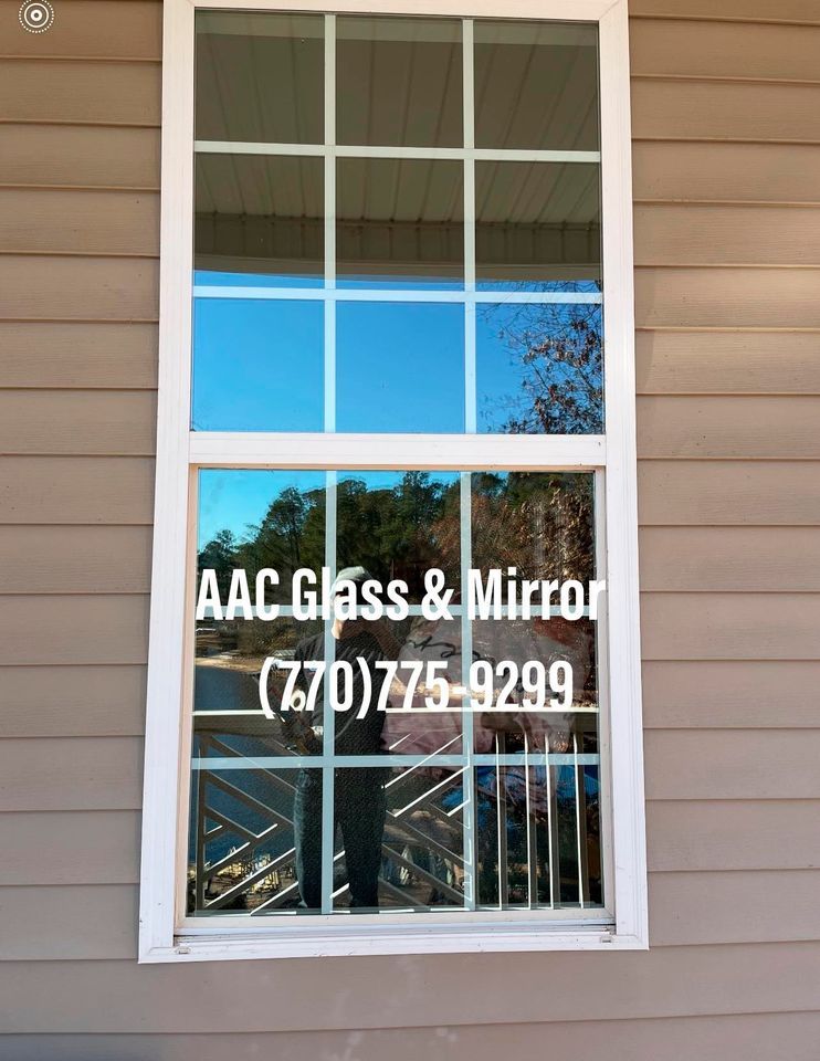 A bathroom with a walk in shower with a glass door.