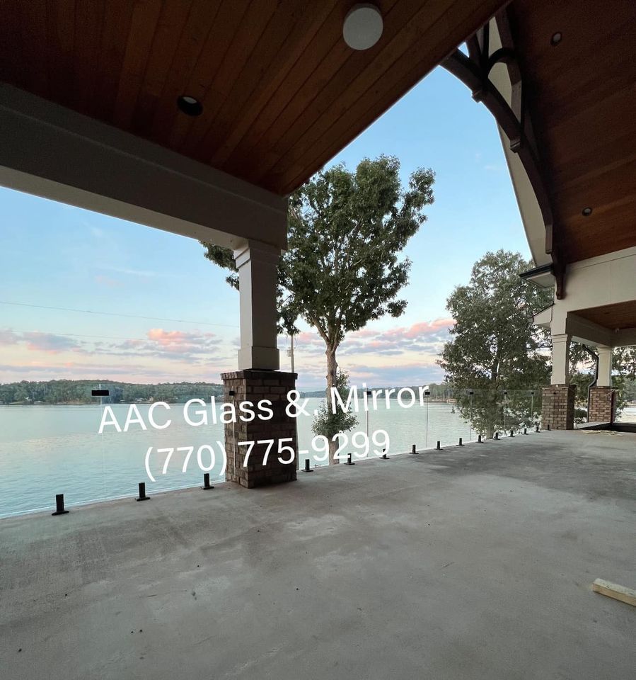A bathroom with a walk in shower with a glass door.