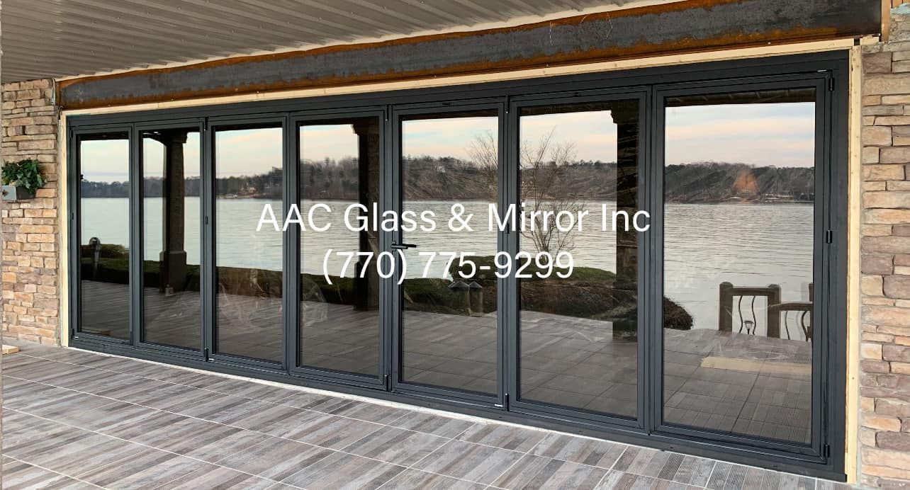 A large sliding glass door with a view of a lake.
