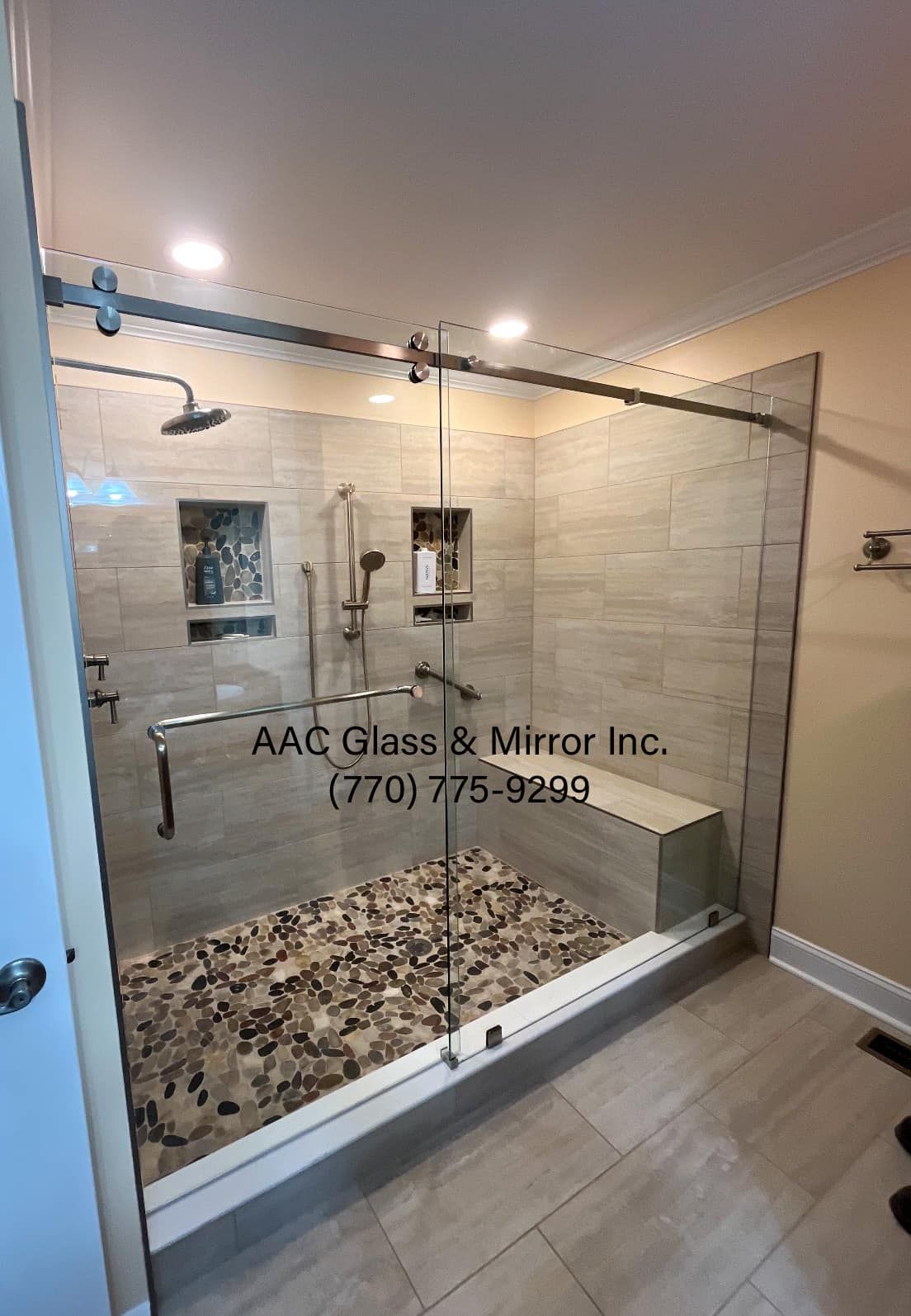 A bathroom with a walk in shower with a sliding glass door.