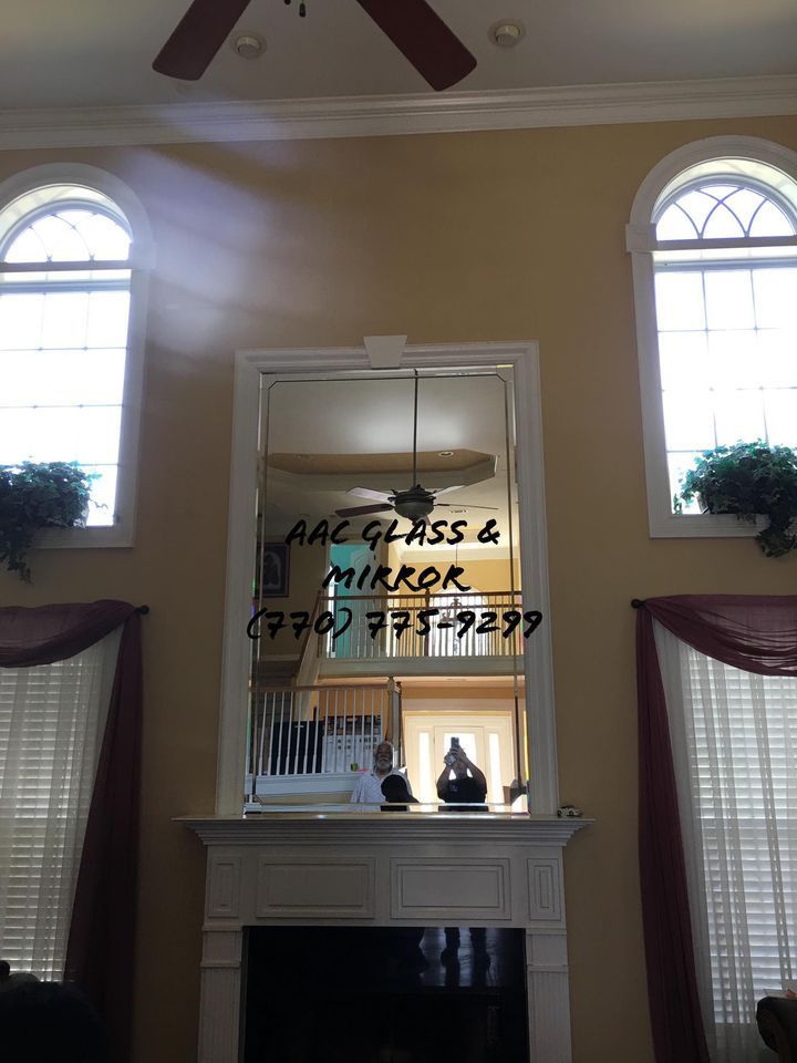 A bathroom with a walk in shower with a glass door.
