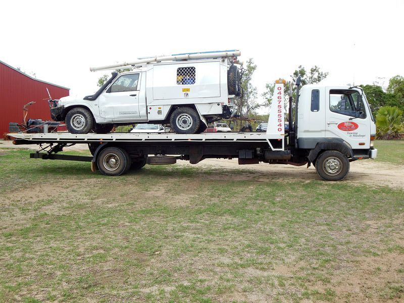 A Tow Truck With a White Truck on the Back of It — Ringtail Towing in Mareeba, QLD