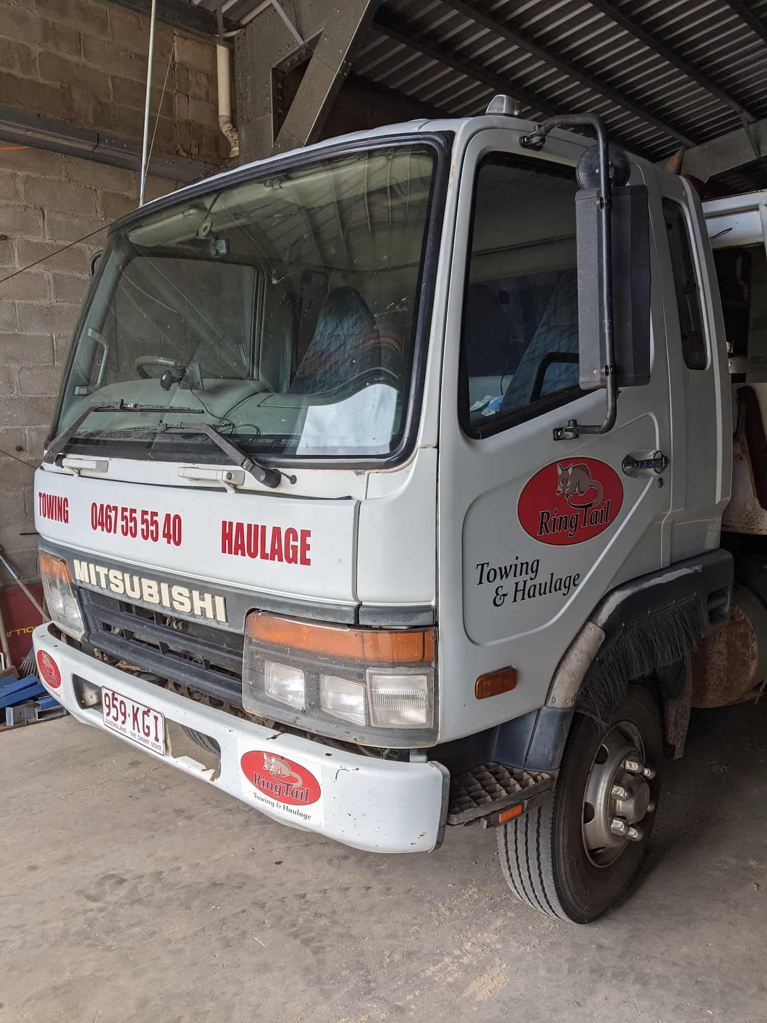 White Mitsubishi Tow Truck With Red Logo, Parked Indoors — Ringtail Towing in Mareeba, QLD