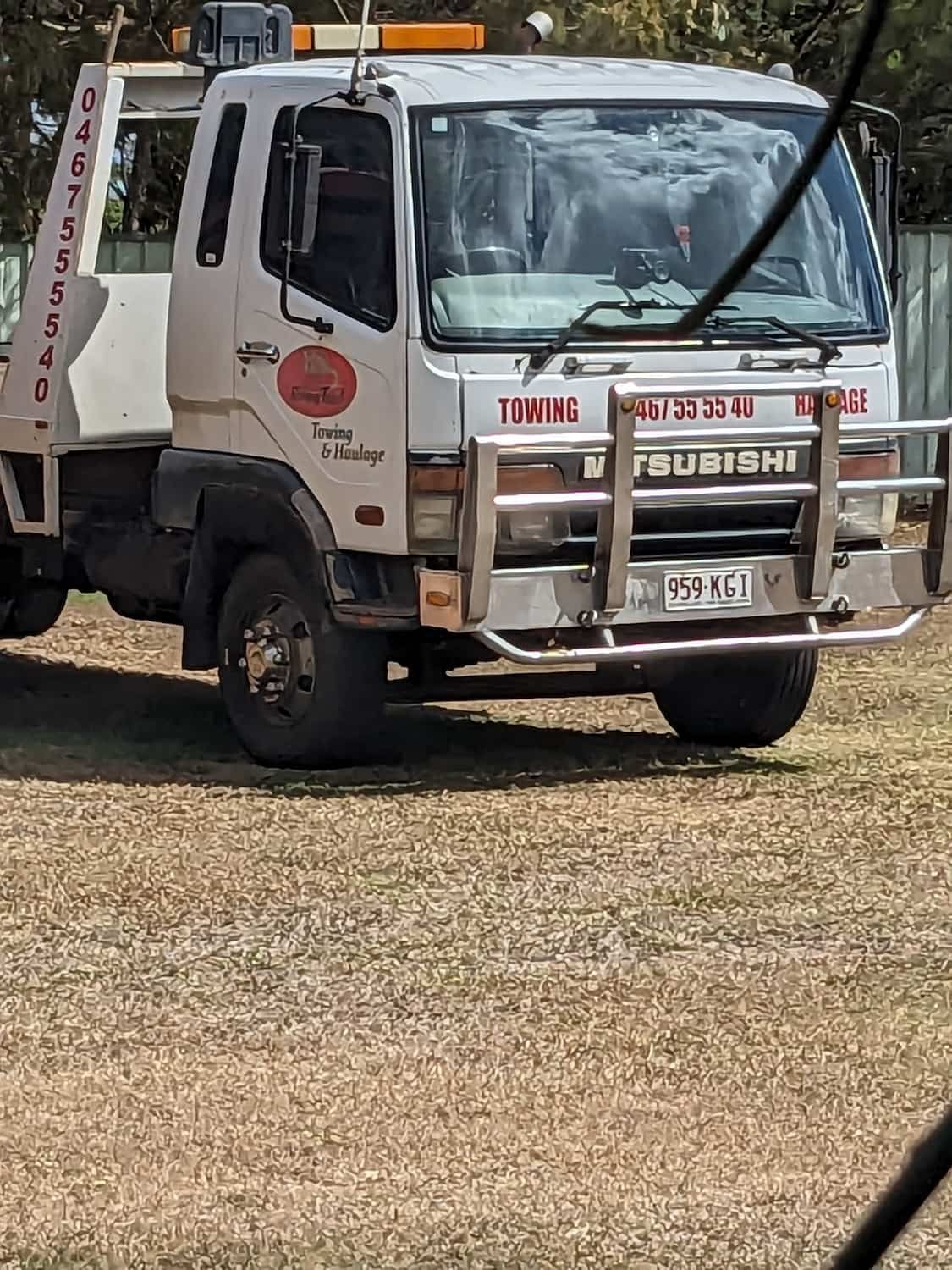 White Tow Truck With a Mitsubishi Logo Parked on Gravel — Ringtail Towing in Mareeba, QLD